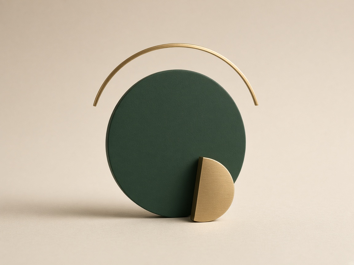 A deep green disc, a brass arc, and a brass half-coin.